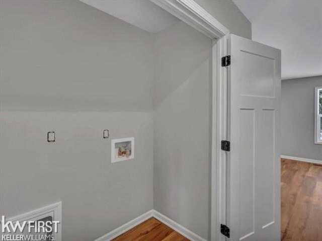 washroom with washer hookup and hardwood / wood-style floors