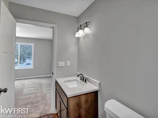 bathroom featuring vanity and toilet