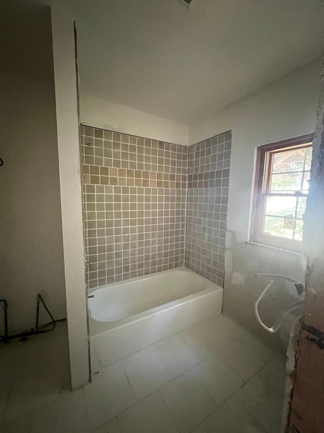 bathroom with tile patterned floors and tiled shower / bath