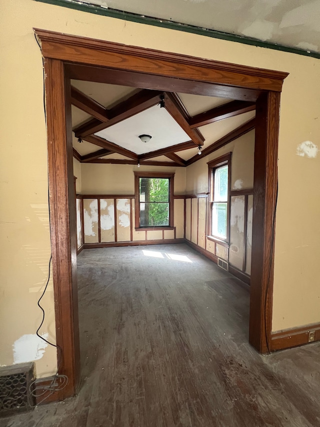 unfurnished living room featuring beam ceiling, dark hardwood / wood-style flooring, and coffered ceiling