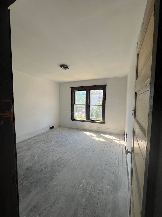 unfurnished room featuring hardwood / wood-style floors