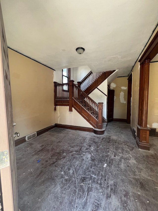 unfurnished living room with ornate columns