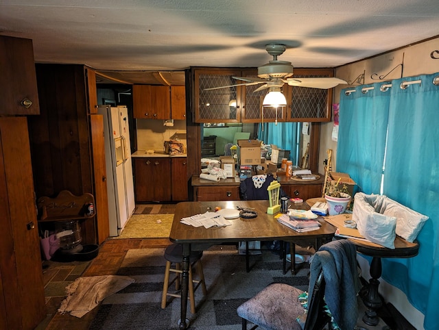 dining space featuring ceiling fan, dark parquet floors, and a textured ceiling