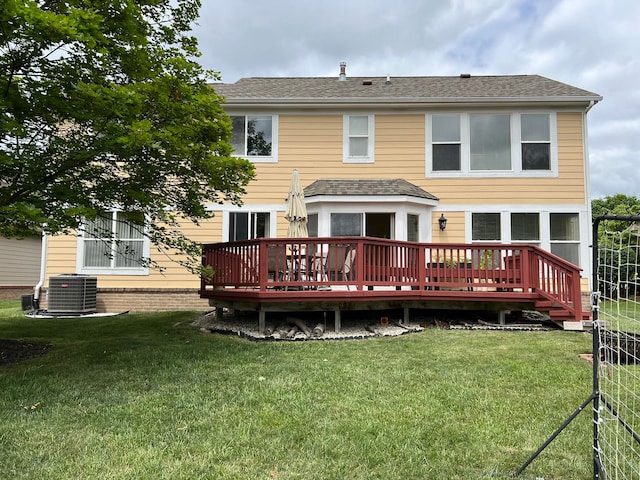 back of house with a lawn, central AC unit, and a deck