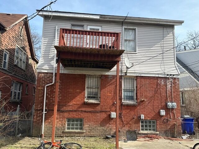 rear view of property featuring a balcony