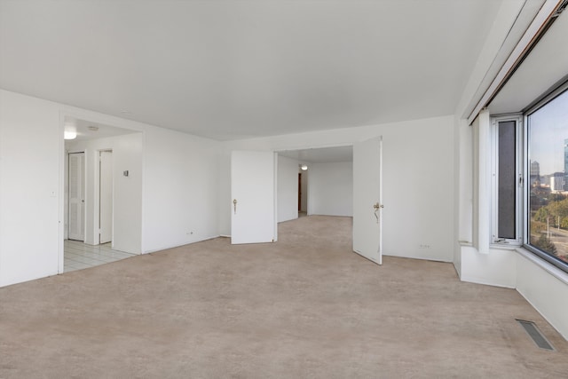 empty room featuring light colored carpet