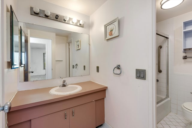 full bathroom with vanity, toilet, tile walls, and tiled shower / bath combo