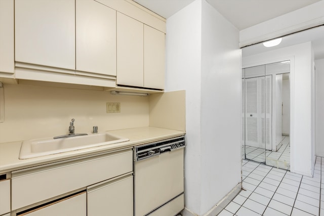 kitchen with dishwasher, light tile patterned floors, and sink