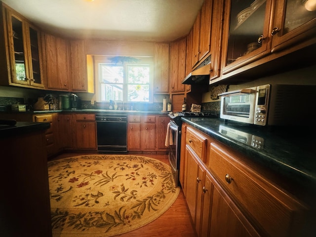 kitchen with electric range, dishwasher, sink, and hardwood / wood-style floors