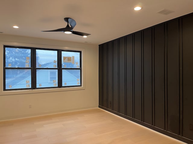 empty room with light wood-type flooring and ceiling fan