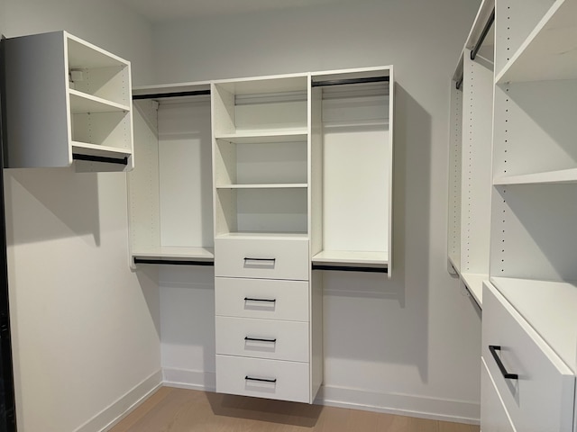 spacious closet featuring light hardwood / wood-style flooring