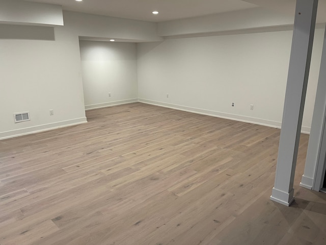 basement with light hardwood / wood-style floors