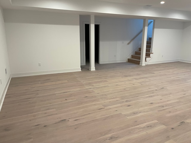 basement with light hardwood / wood-style flooring