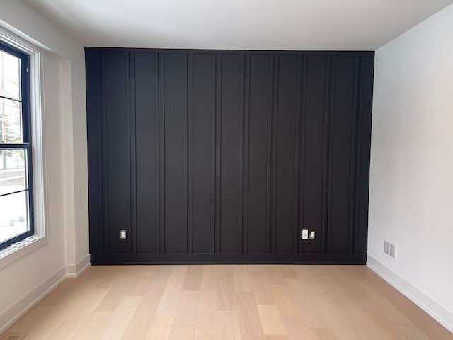 unfurnished room featuring a healthy amount of sunlight and light hardwood / wood-style flooring