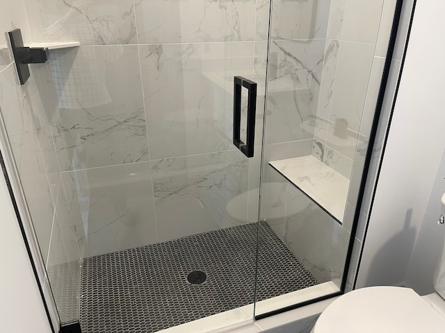 bathroom with walk in shower and toilet