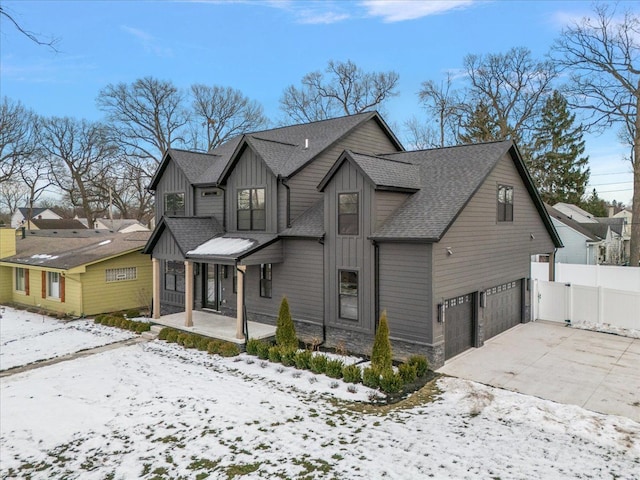 view of snowy exterior featuring a garage