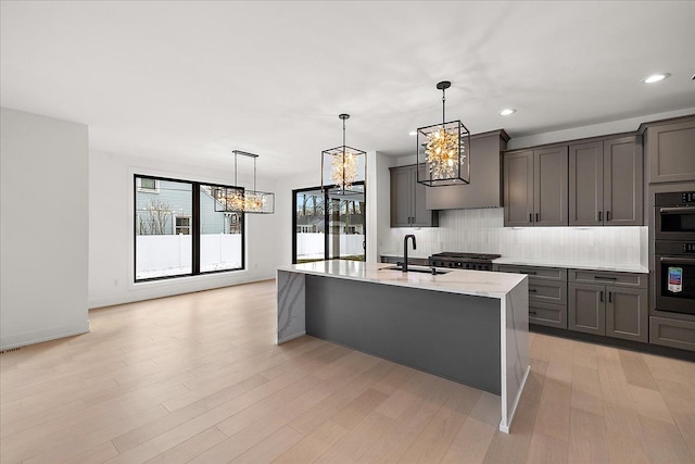 kitchen featuring sink, decorative backsplash, decorative light fixtures, and appliances with stainless steel finishes