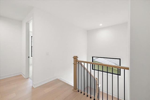 corridor with light hardwood / wood-style flooring