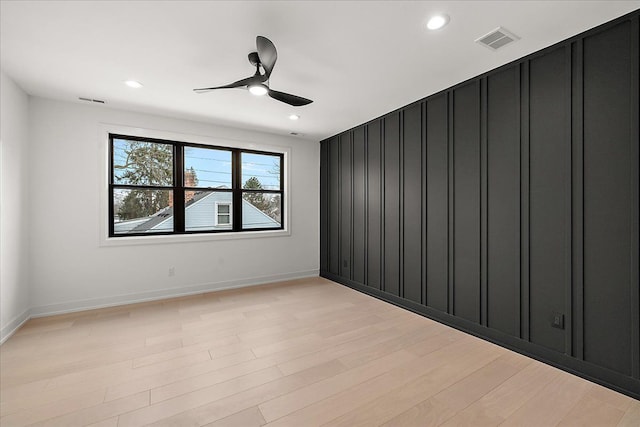 empty room featuring ceiling fan and light wood-type flooring