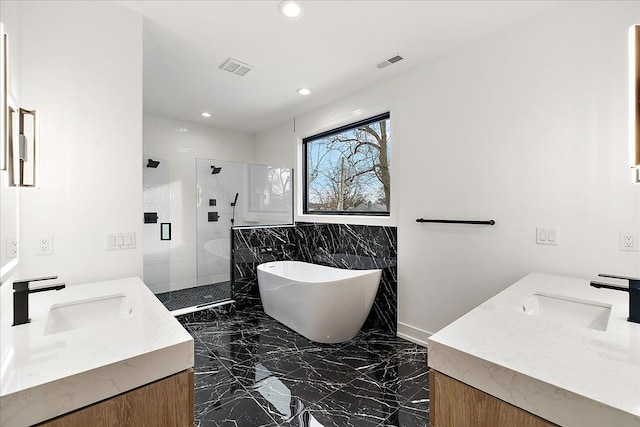 bathroom featuring vanity and separate shower and tub