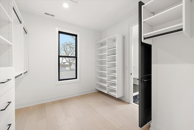 spacious closet featuring light wood-type flooring