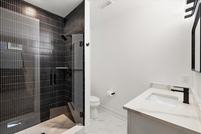 bathroom with vanity, an enclosed shower, and toilet