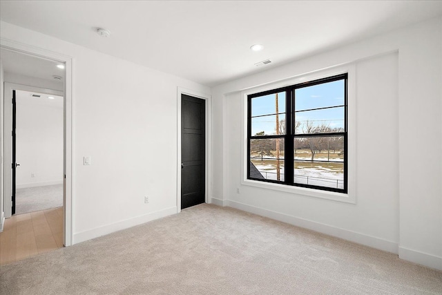 unfurnished bedroom with light carpet