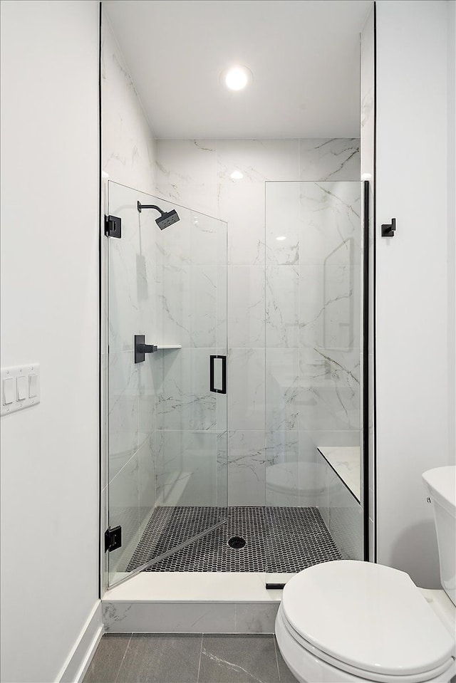 bathroom with an enclosed shower and toilet