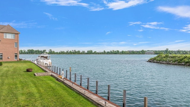 dock area with a yard and a water view