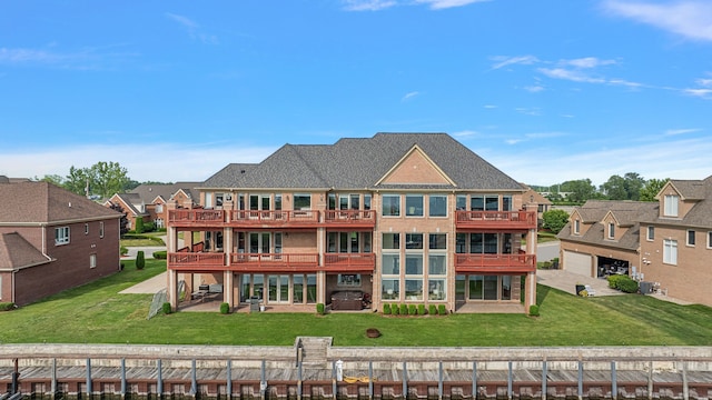 back of property with a lawn and a patio