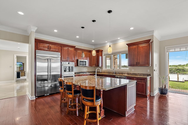 kitchen featuring a kitchen island with sink, plenty of natural light, dark hardwood / wood-style floors, and appliances with stainless steel finishes