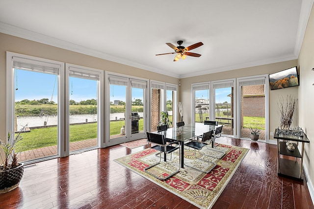 interior space featuring ceiling fan, a water view, and a wealth of natural light