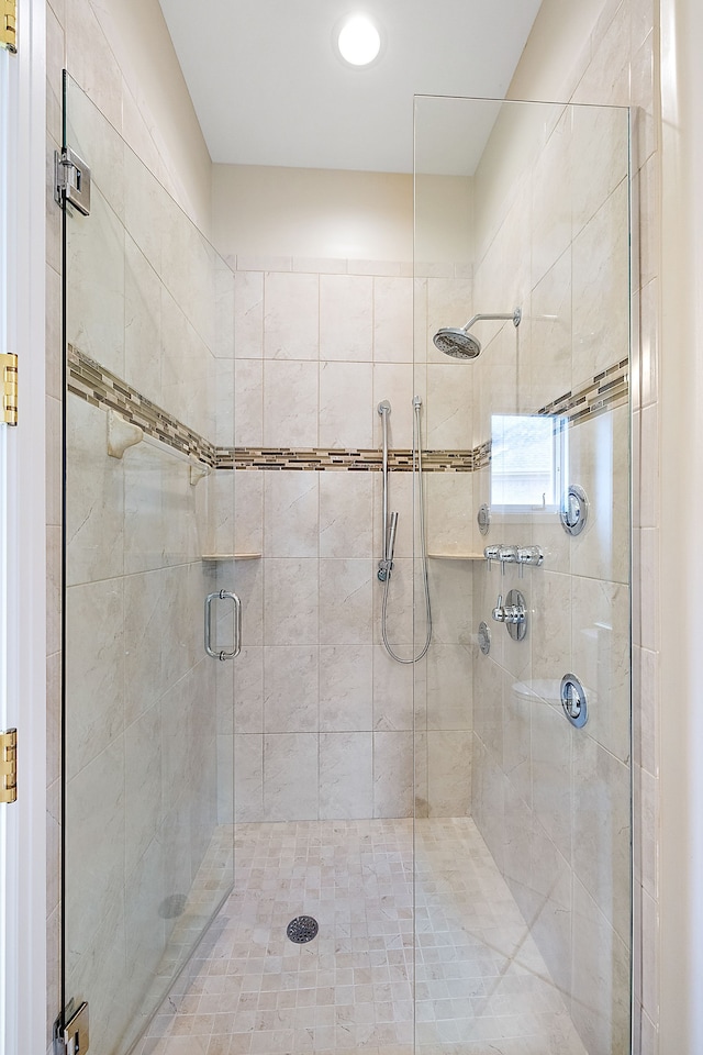 bathroom with a shower with door