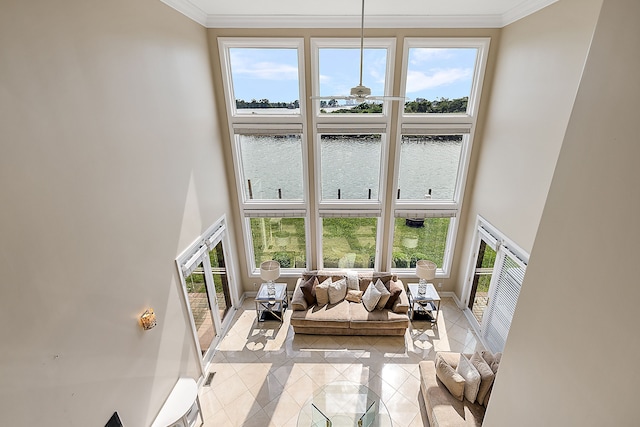 18 Sand Bar Ln, Detroit, MI 48214 - living room with a high ceiling, ornamental molding, light tile patterned flooring, a water view, and baseboards
