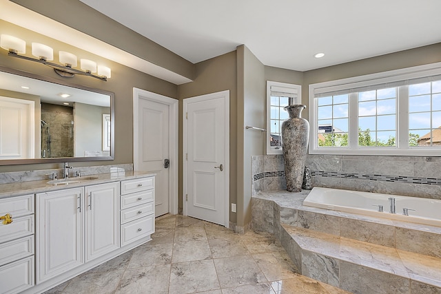 bathroom with vanity and independent shower and bath