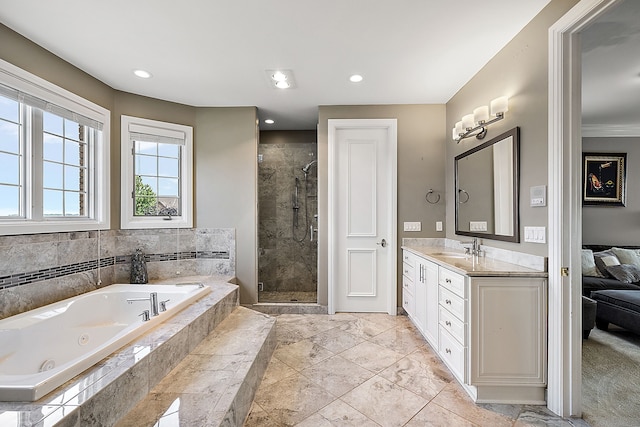 bathroom with vanity, ornamental molding, and shower with separate bathtub