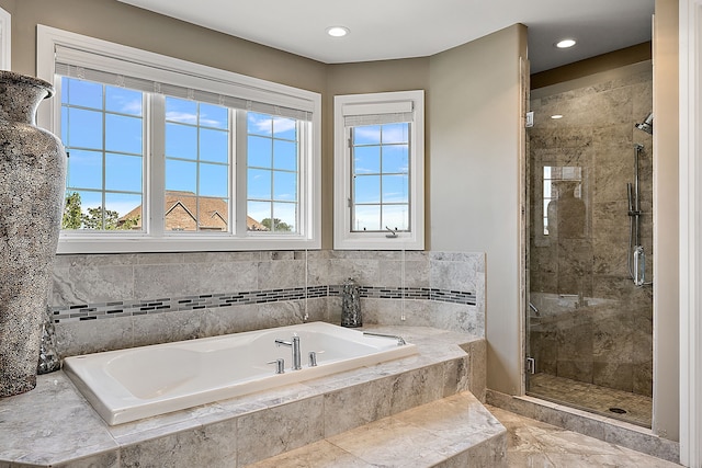 bathroom with plus walk in shower and a wealth of natural light