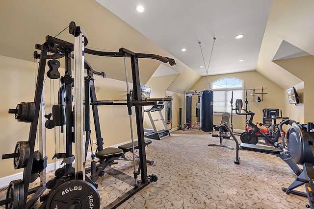 workout room featuring light carpet and vaulted ceiling