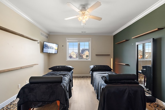 bedroom with ceiling fan, crown molding, and light hardwood / wood-style flooring