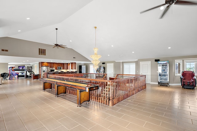 playroom featuring ceiling fan and high vaulted ceiling