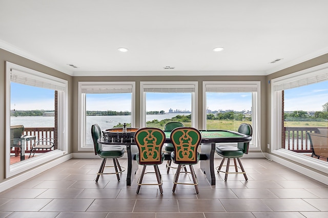 sunroom / solarium with a water view