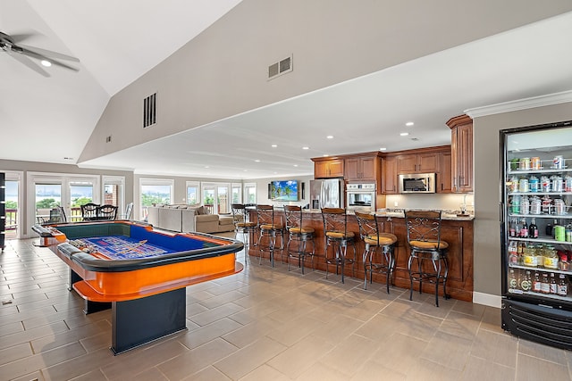 recreation room with high vaulted ceiling and ceiling fan