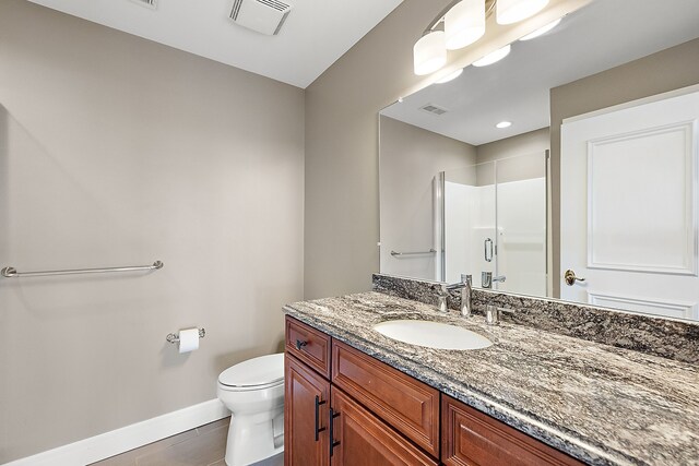 18 Sand Bar Ln, Detroit, MI 48214 - bathroom with baseboards, vanity, a shower stall, and toilet