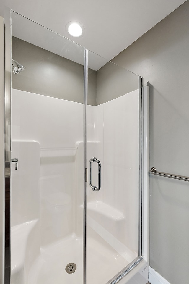 bathroom with a shower with door