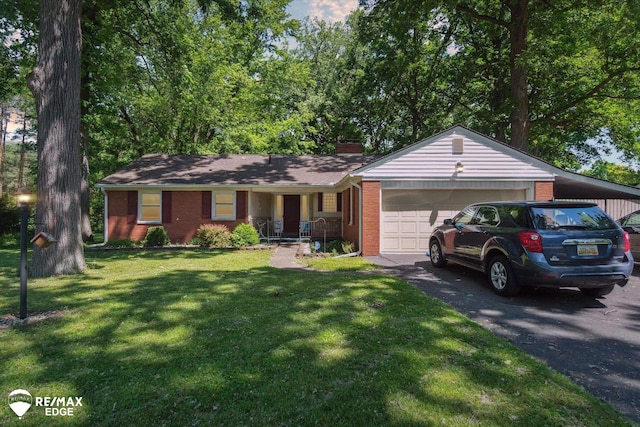 single story home featuring a garage and a front lawn