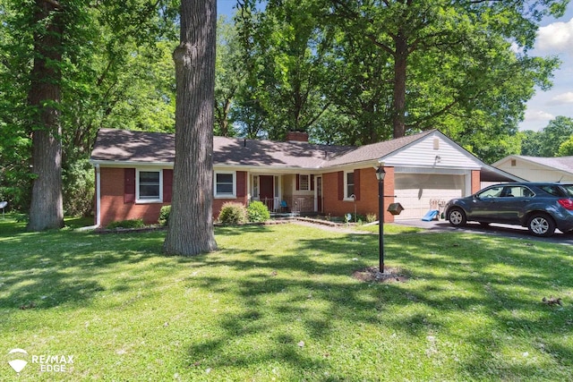 ranch-style house with covered porch, a garage, and a front yard