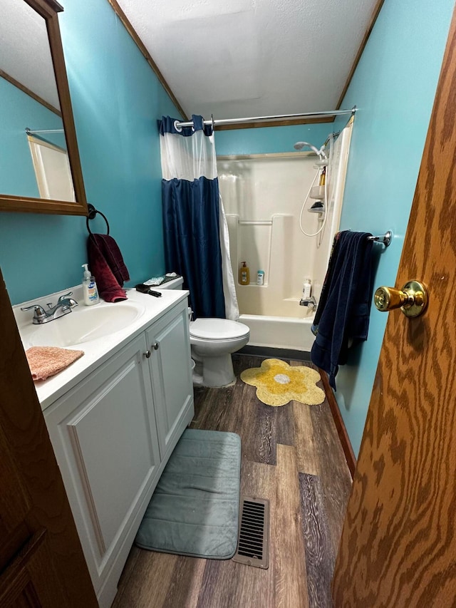 full bathroom featuring hardwood / wood-style flooring, vanity, toilet, and shower / bath combo with shower curtain