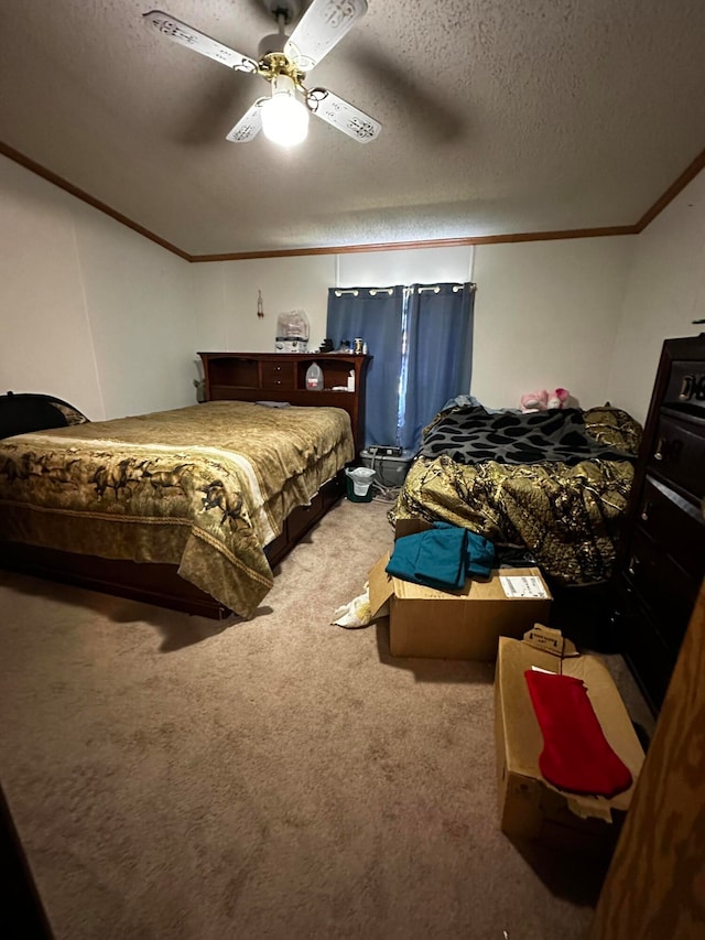 carpeted bedroom with a textured ceiling, ceiling fan, and ornamental molding