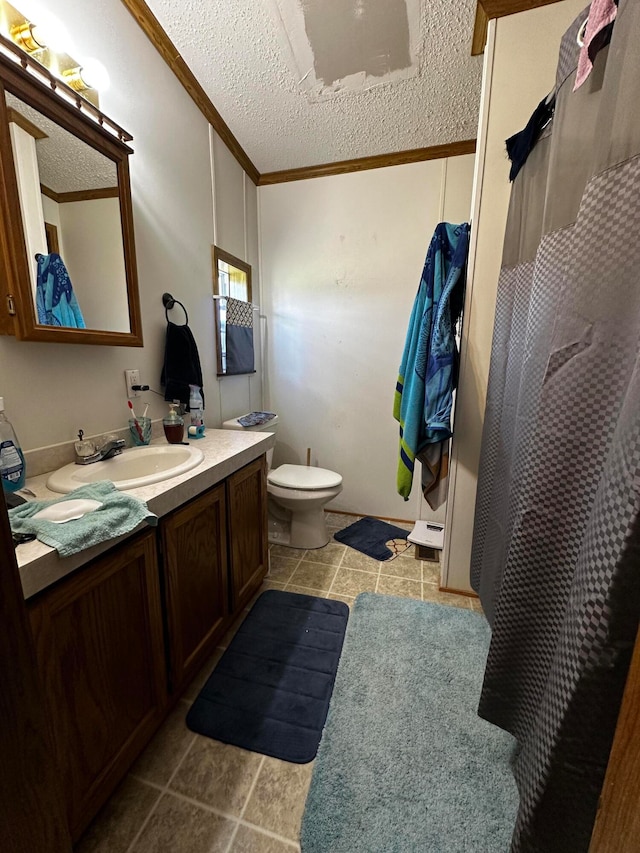 bathroom with vanity, a textured ceiling, toilet, and ornamental molding