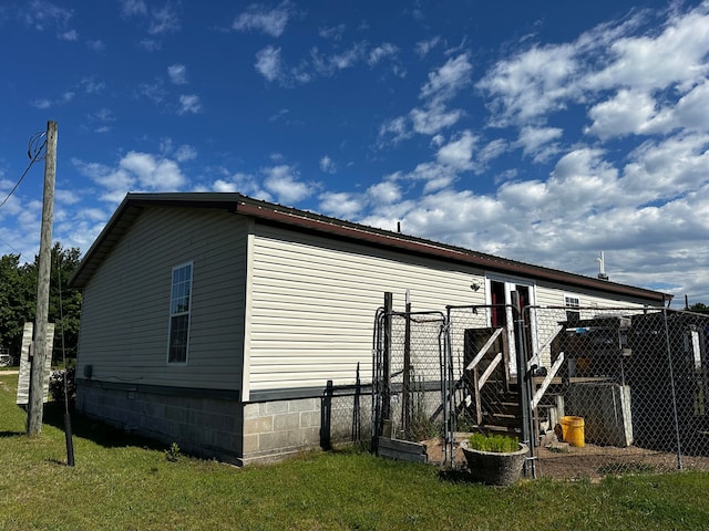 view of side of home with a lawn